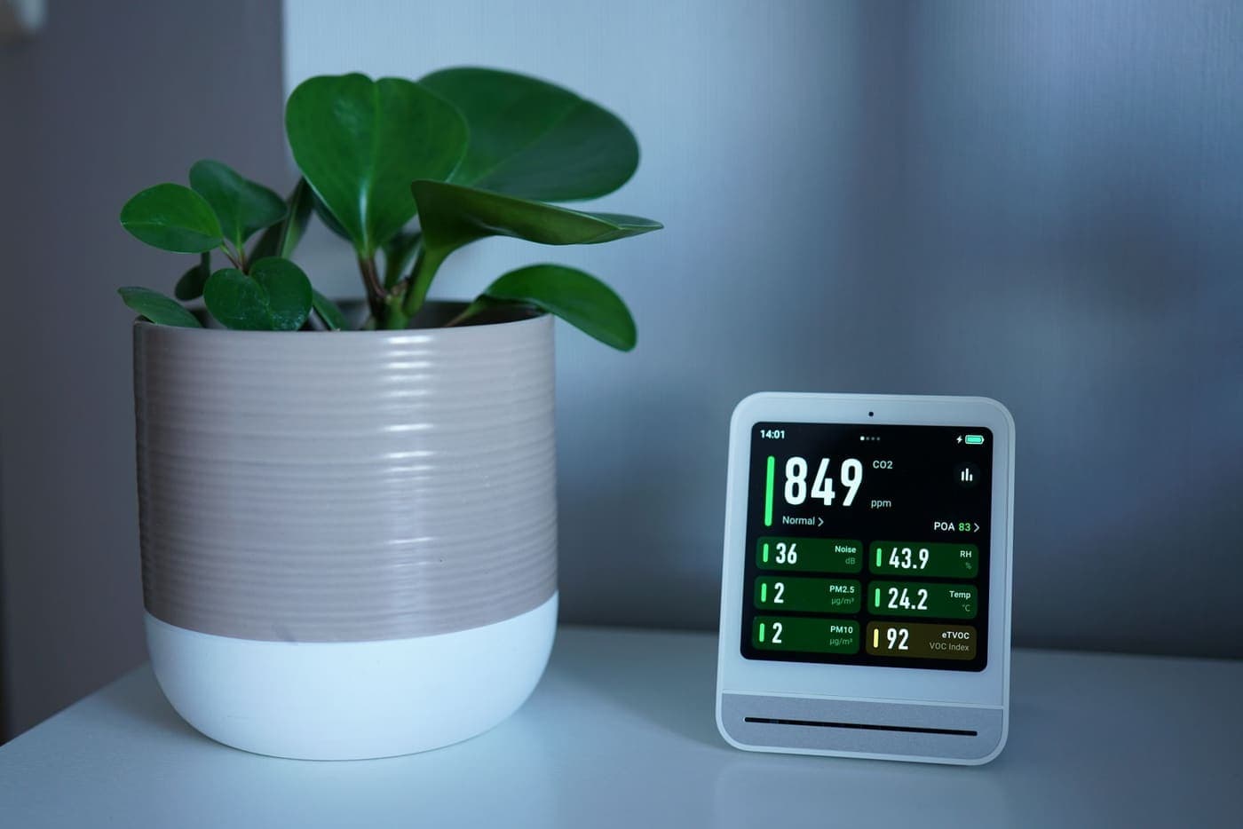 Indoor air quality monitor on a shelf in a home