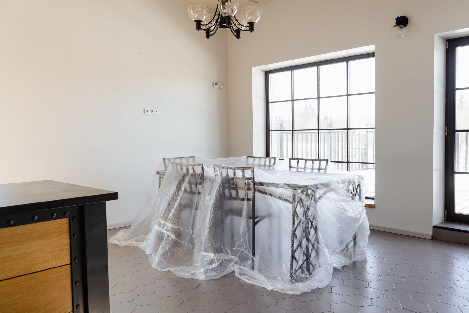 Room contents covered in plastic sheeting during containment work