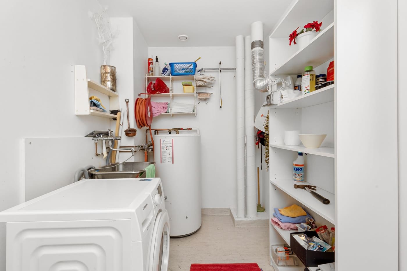 Front-load washer in a home utility room with water heater